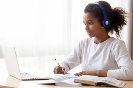 Girl using headphones on laptop