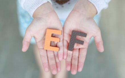 2 hands holding the letters e and f