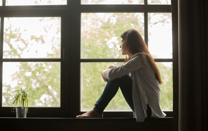 Girl sat at a window