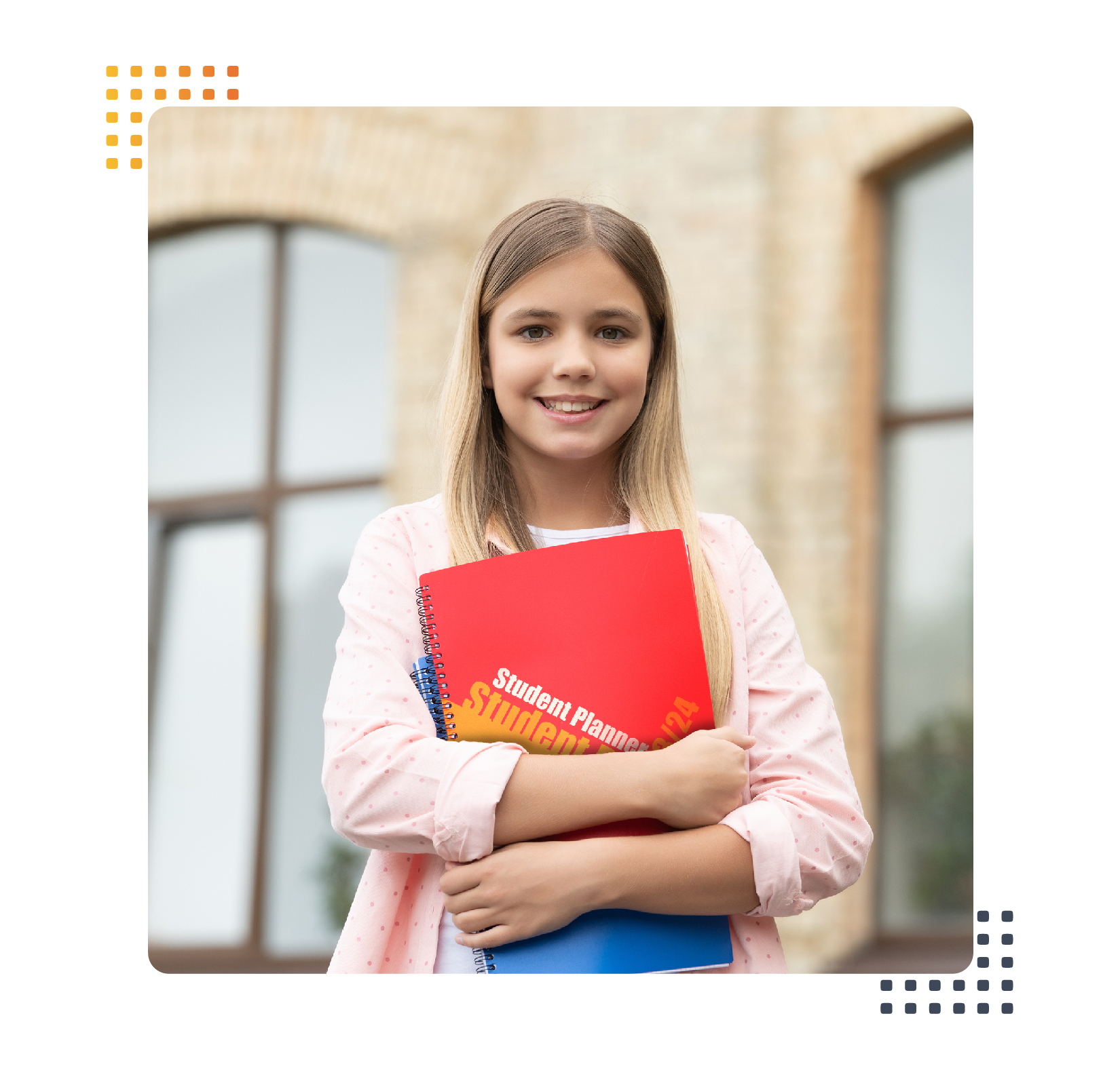 girl holding a planner in front of a school building