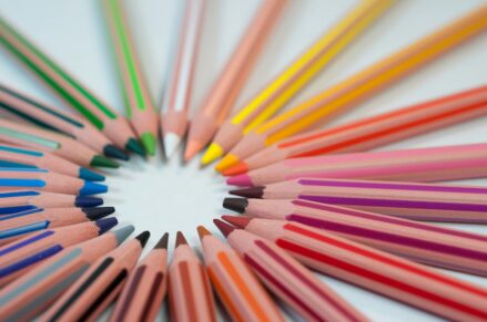 colored pencils arranged in a circle by color